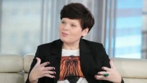 A woman is sitting on a couch and talking.