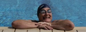 A woman in a swimming cap and goggles.