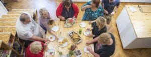 A group of people sitting around a table eating food.