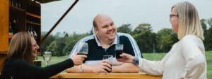 A group of people drinking wine at a bar.