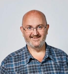 A man wearing glasses and a plaid shirt.