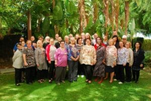 A group of people posing for a photo in a garden.