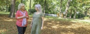 Two older women talking in a park.