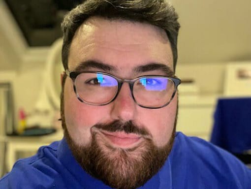 A man with glasses and a beard.