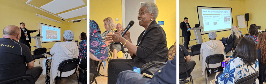 A presenter speaks to an audience in a yellow-walled room; one woman holds a microphone to ask a question during the session.